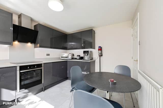 The modern fitted kitchen forms part of a spacious ground-floor layout that also includes a utility room