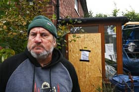 Scott Lumsdon, 58, outside of his boarded up back door.