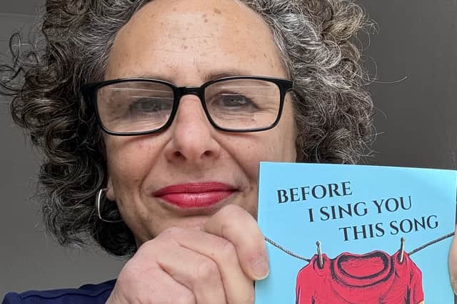 Justine Sless with her new book Before I Sing You This Song.