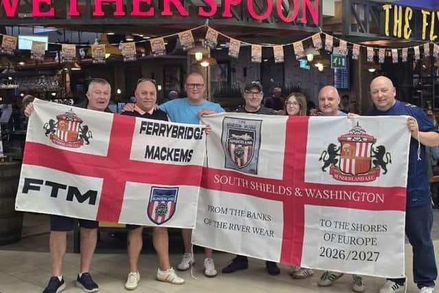 Peter Oliver, in the blue shirt at the centre, joins other fans who set off from Gatwick for Portugal last week.