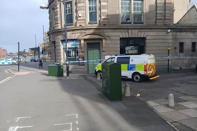 There is a significant police presence outside of the Wheatsheaf pub.