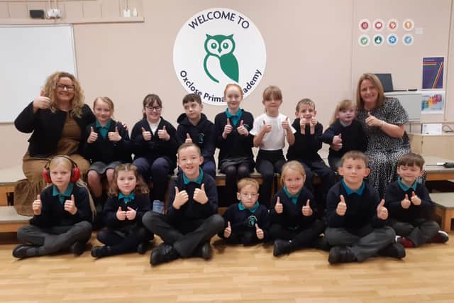 Headteacher Audrey Bolam and deputy headteacher Angela Butler celebrate their Ofsted report with the school's children.