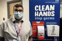 Dr Shaz Wahid at a hospital hygiene station.