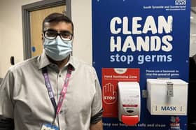 Dr Shaz Wahid at a hospital hygiene station.