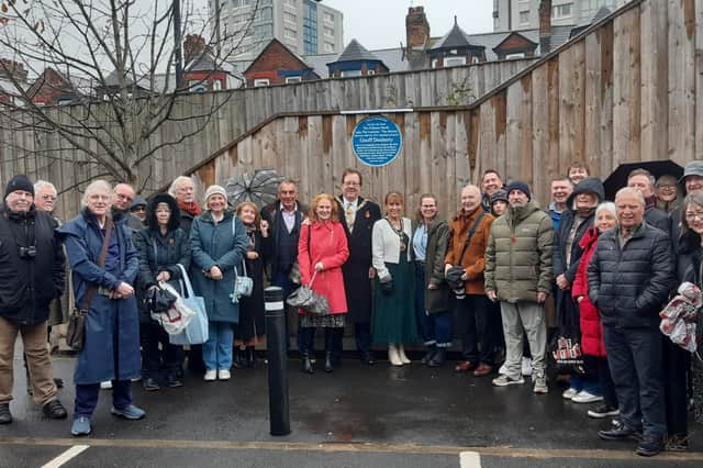 Friends of former music promoter Geoff Docherty gather for the unveiling of the blue plaque in his honour.