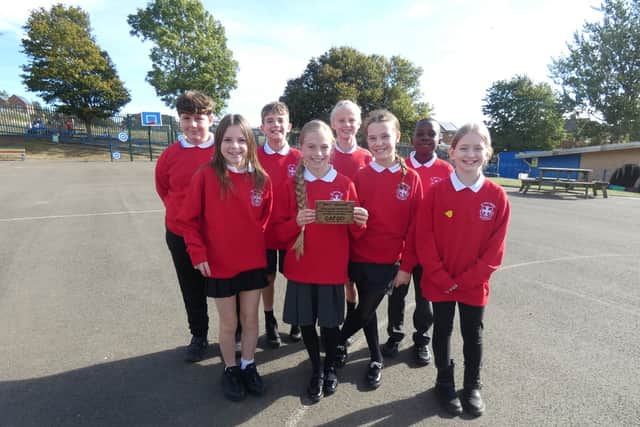 Pupils from St John Bosco proudly display their Live Simply Award.