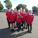 Pupils from St John Bosco proudly display their Live Simply Award.