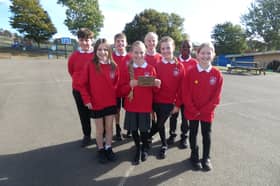 Pupils from St John Bosco proudly display their Live Simply Award.