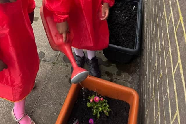 Children watering plants at Sunderland Millfield Salvation Army 