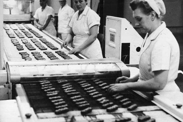 Toffee crisp bars flow along a conveyor belt at Mackintosh sweet factory in 1963.