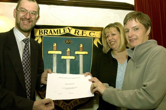 John Battle MP signs up for the first share certificate in the new Bramley RLFC given to him by two of the new directors Helen Colbeck and Vanessa Burnley at the Old Vic pub.