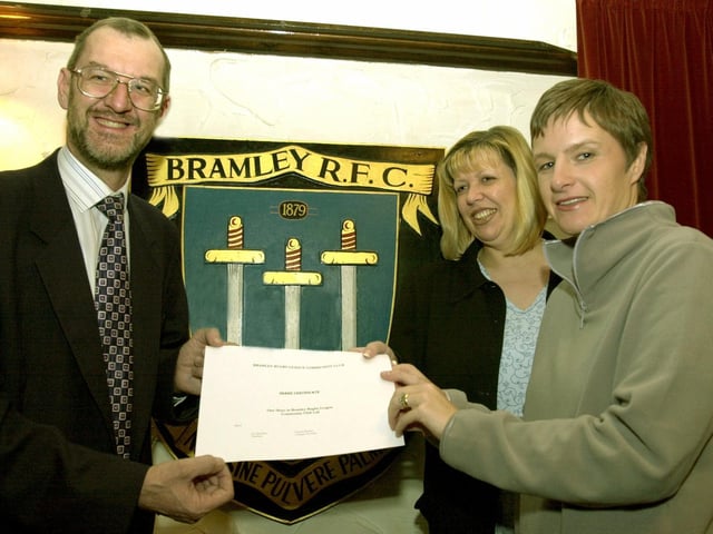 John Battle MP signs up for the first share certificate in the new Bramley RLFC given to him by two of the new directors Helen Colbeck and Vanessa Burnley at the Old Vic pub.