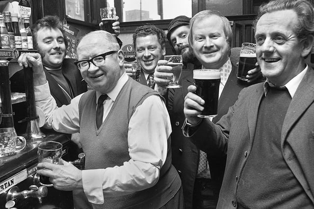 Landlord Colin Cook and regulars at the Market Hotel in Wigan in 1974.