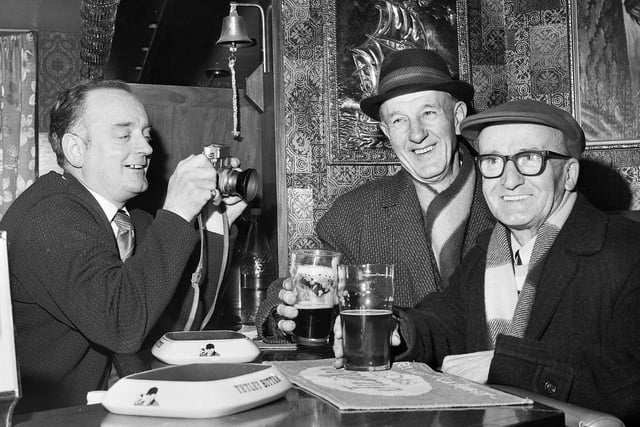 Landlord of the Victoria Hotel on Liverpool Road, Platt Bridge, John Lyon, left, takes a picture of regulars Arthur Shuttleworth and Horace Waterworth in January 1972.
John was a wedding photographer before becoming a licensee.