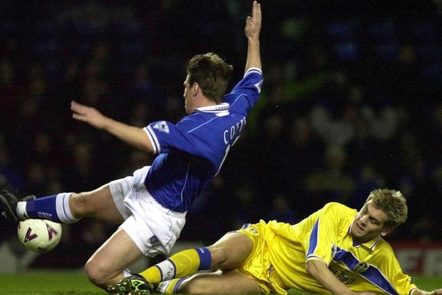 Leicester City striker Tony Cottee slides past Jonny Woodgate during the  Worthington Cup fourth round clash at Filbert Street in December 1999. Leeds won 6-0.