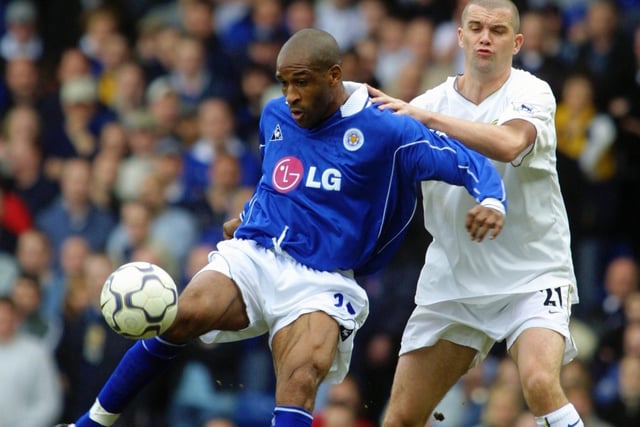 Leicester City striker Brian Deane holds the ball up against Dominic Matteo.