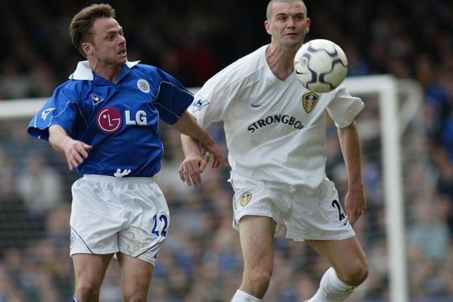 Leicester City striker Paul Dickov and Dominic Matteo battle for the ball.