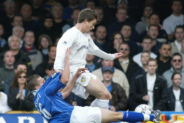 Leicester City's Lee Marshall slides in to tackle Harry Kewell.