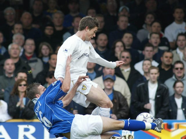 Leicester City's Lee Marshall slides in to tackle Harry Kewell.