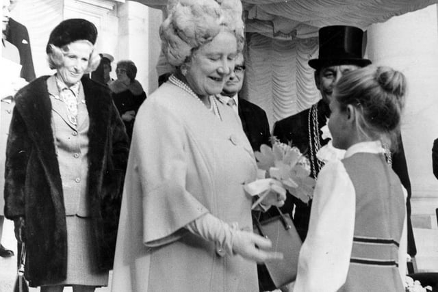 Pictured is seven-year old Julia King, daughter of crew member, Petty Officer Electrician, Ian King, presenting Her Majesty with a posy of flowers.