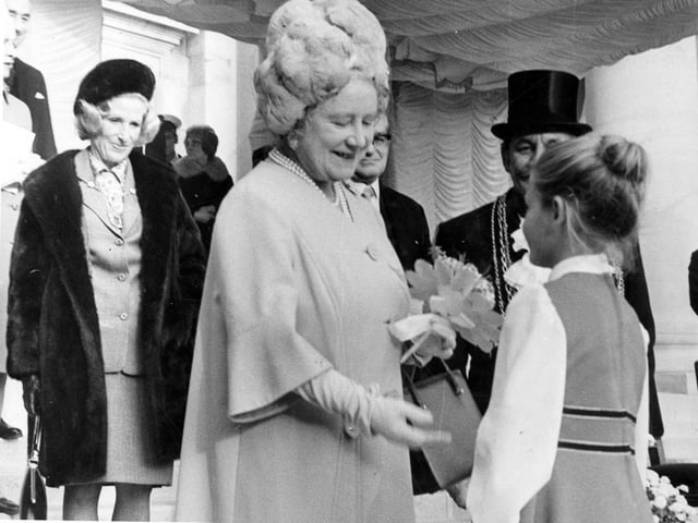 Pictured is seven-year old Julia King, daughter of crew member, Petty Officer Electrician, Ian King, presenting Her Majesty with a posy of flowers.