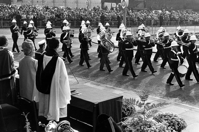 Bands of the Commander in Chief of the Fleet and Ark Royal are performing a march past outside the Civic Hall. In the foreground the great Mace of Leeds is visible, held by the Mace Bearer.
