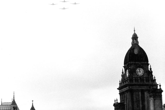 Fly-past of aircraft over the city centre, with Leeds Town Hall on the right.