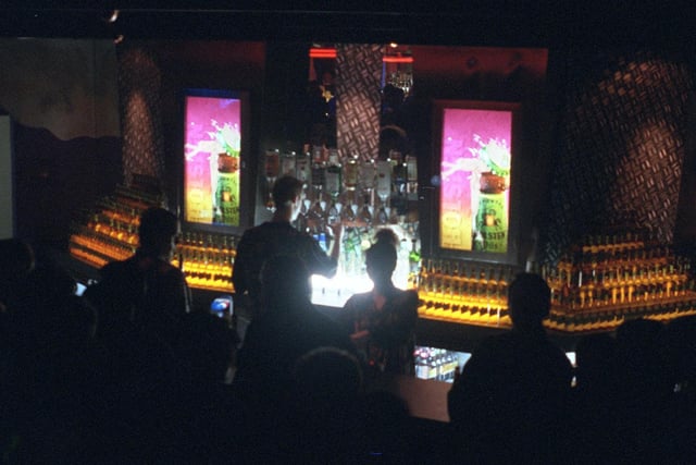 People queue for a beverage at one of the superclub's busy bars