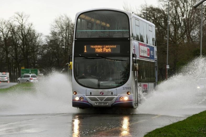 A bus making its way through flood water on Otley Road.