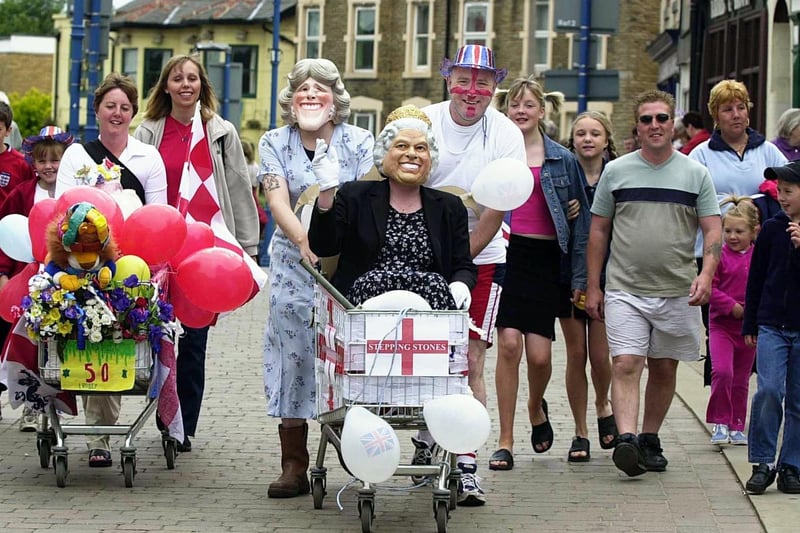 June 2002 and Rothwell pub teams from pubs The Stepping Stones (centre) and Coach and Horses (left) took part a the fancy dress trolley push in the town centre as part of Rothwell Golden Jubilee Celebrations.