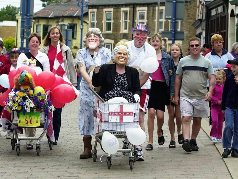 June 2002 and Rothwell pub teams from pubs The Stepping Stones (centre) and Coach and Horses (left) took part a the fancy dress trolley push in the town centre as part of Rothwell Golden Jubilee Celebrations.