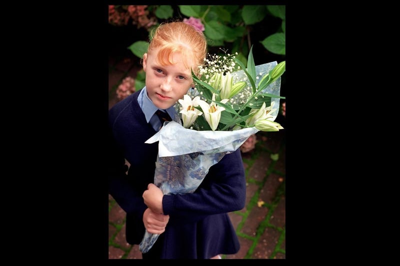 Stacey Beetham (13) with her bouquet of flowers for the school memorial