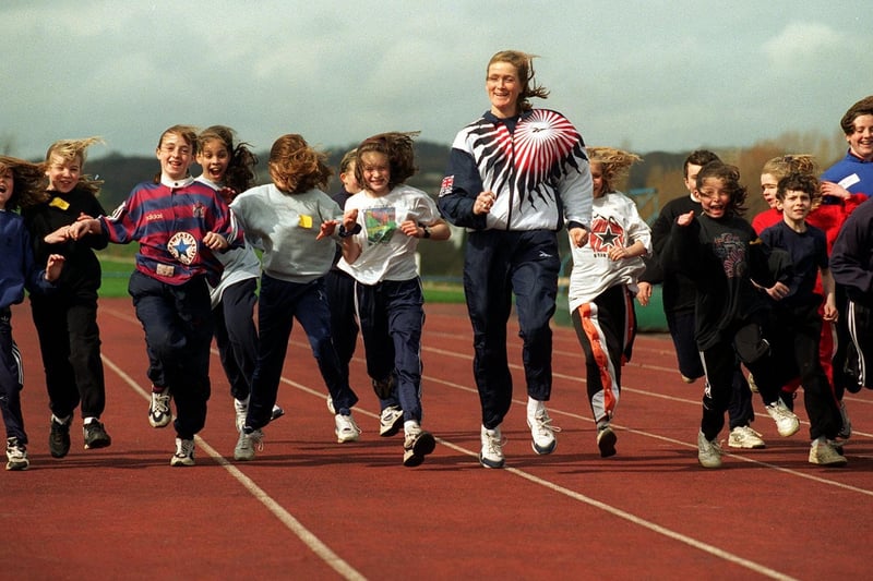Great Britain 800m runner Michelle Faharty (centre) tutors youngsters on the Beckett Park athletics track.