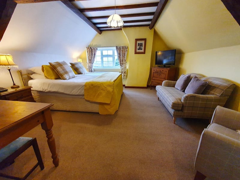 Another of the hotel's large bedrooms, with exposed beams on the ceiling.
