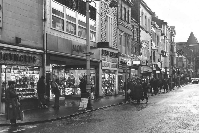 Another photo looking up the street, this one from December 1983. You can see the sign for "Rudies Nightscene" (beneath the clock) and a trio of menswear shops - John Collier, Ray Alan and Dunn & co.