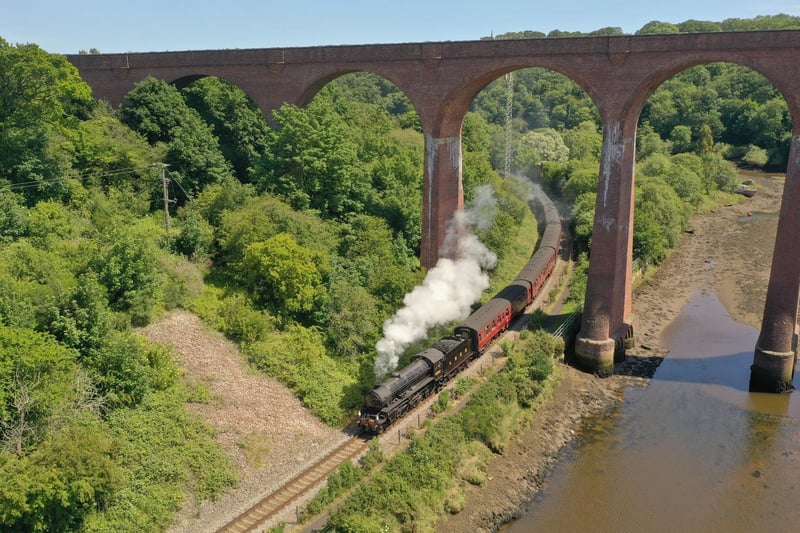 The steam train passing beneath the viaduct