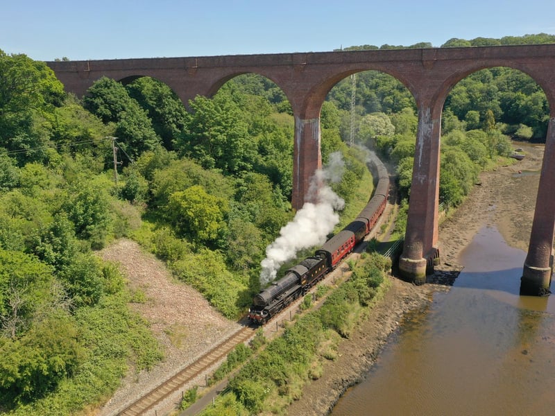 The steam train passing beneath the viaduct