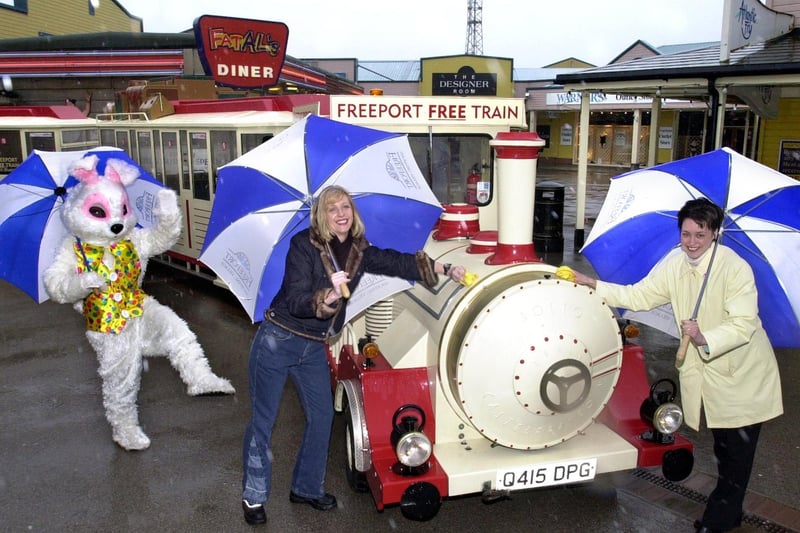 Polishing up the Freeport Road Train at Freeport Outlet Shopping Village in Fleetwood, 2001, are Shauna Harley of Lee Wrangler and Louise Nicholson (right) of Moss Bros, watched by Freeport's Easter Bunny.