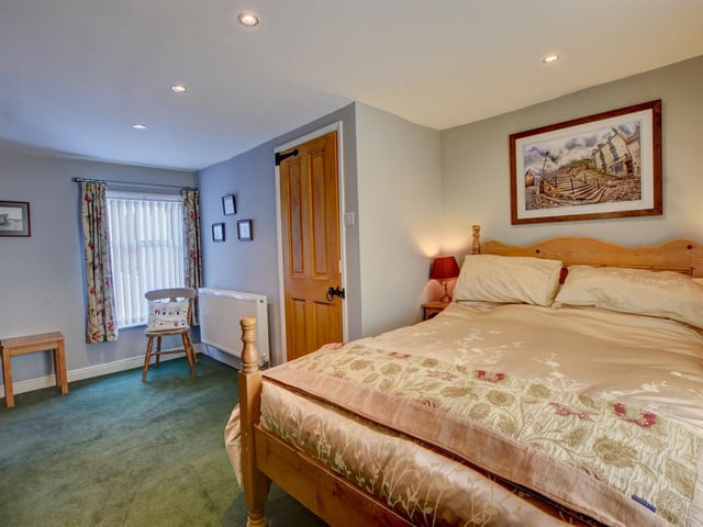 This bedroom and the modern bathroom are on the second floor of the cottage.
