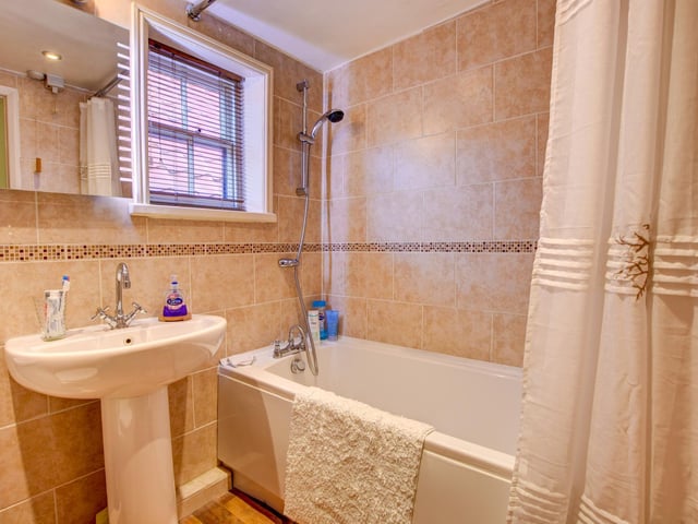 The property's bathroom includes both bath and shower, and is fully tiled.
