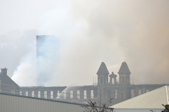 A silhouette of the building as it is shrouded in smoke from the fire.