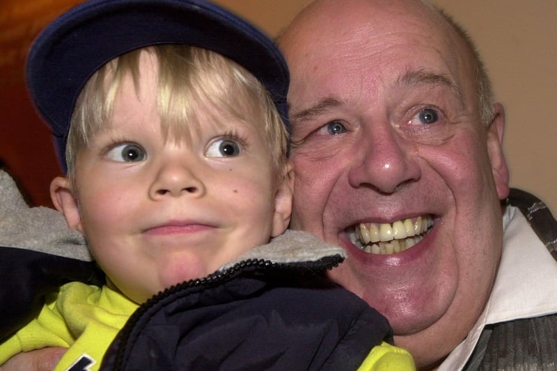 Coronation Street actor John Savident is pictured with young Johnathan Jefferson during a visit to Cross Gates.