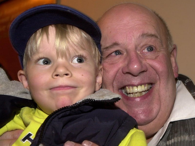 Coronation Street actor John Savident is pictured with young Johnathan Jefferson during a visit to Cross Gates.