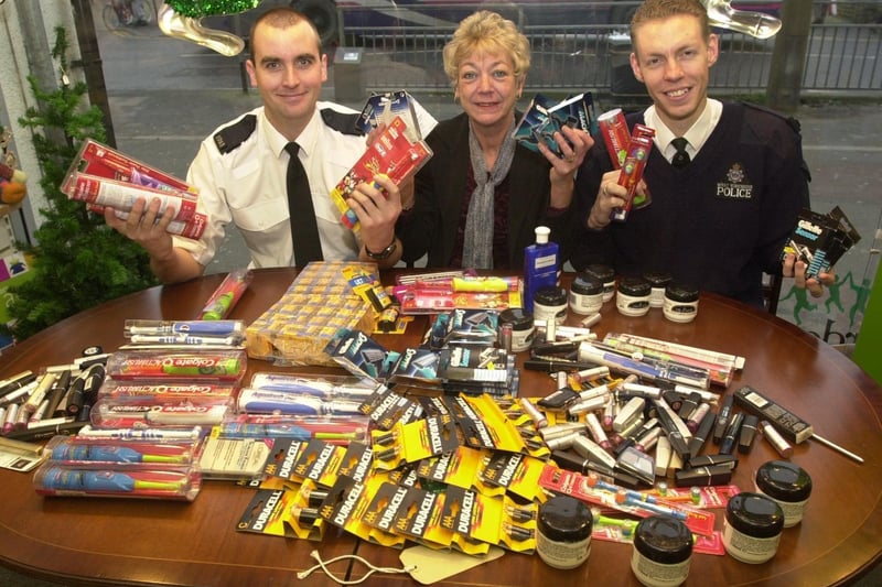 Killingbeck police officers PC Paul Mcguinness (left) and PC James Bruce donate stolen products to Barnardo's manager, Jill Johnson, at her shop in Cross Gates.