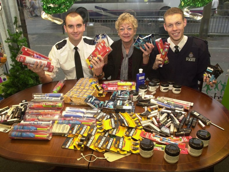 Killingbeck police officers PC Paul Mcguinness (left) and PC James Bruce donate stolen products to Barnardo's manager, Jill Johnson, at her shop in Cross Gates.