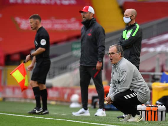 REMATCH: Between Leeds United head coach Marcelo Bielsa, right, and Liverpool boss Jurgen Klopp, centre, pictured during September's 4-3 epic at Anfield. Photo by PAUL ELLIS/POOL/AFP via Getty Images.