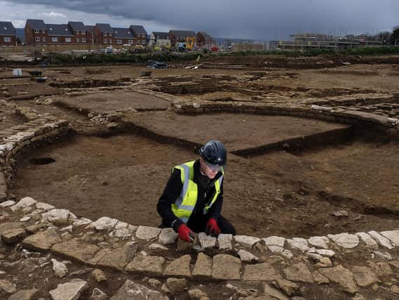 Trainee Field Archaeologist Corey Greening works on the site.