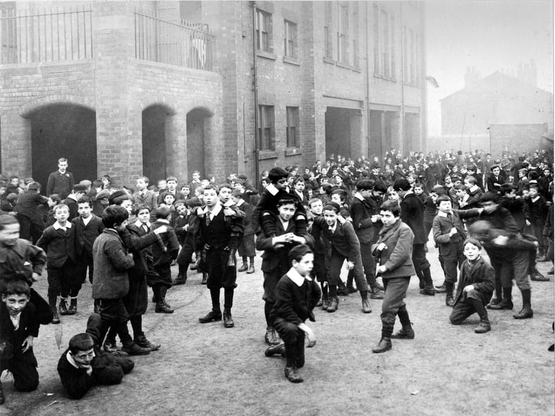 Darley Street School playground full of boys, all indulging in some form of physical activity.