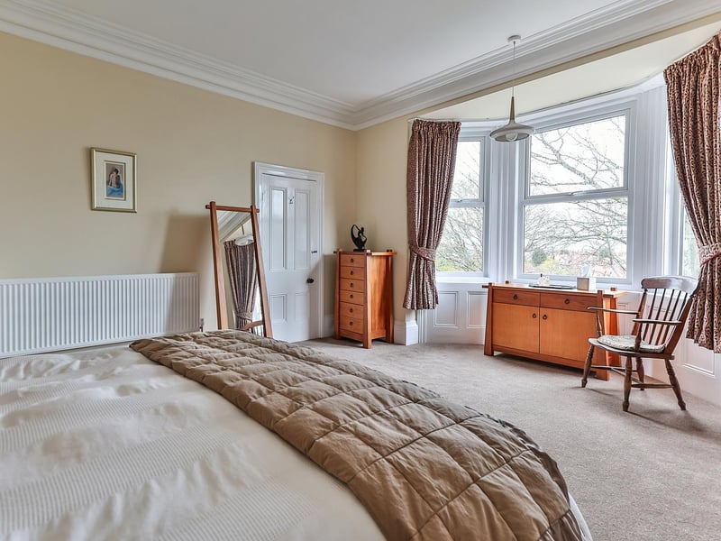 A lovely big bedroom with bay window within the property