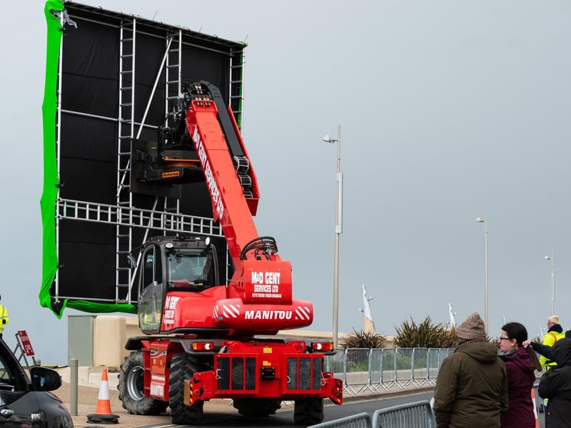 The giant green screens moved in